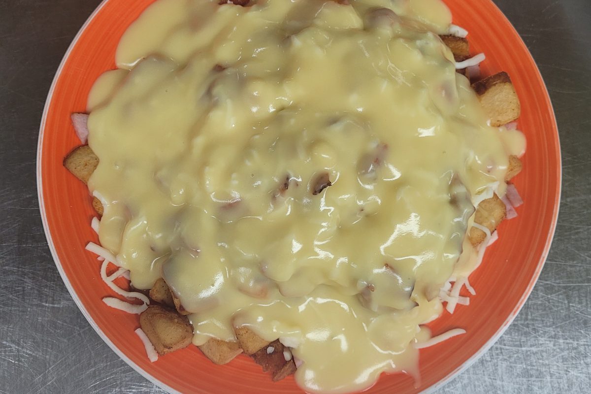 Bacon and ham breakfast poutine with hollandaise