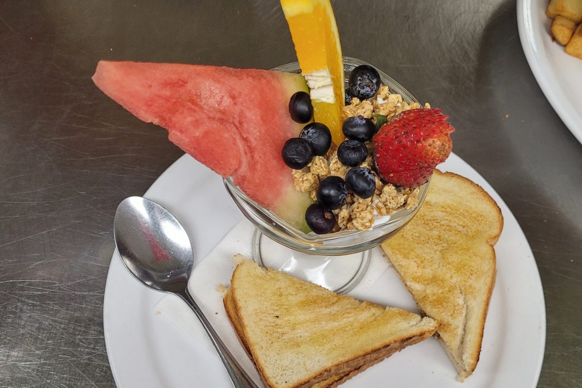 Strawberry blueberry yogurt parfait with toast