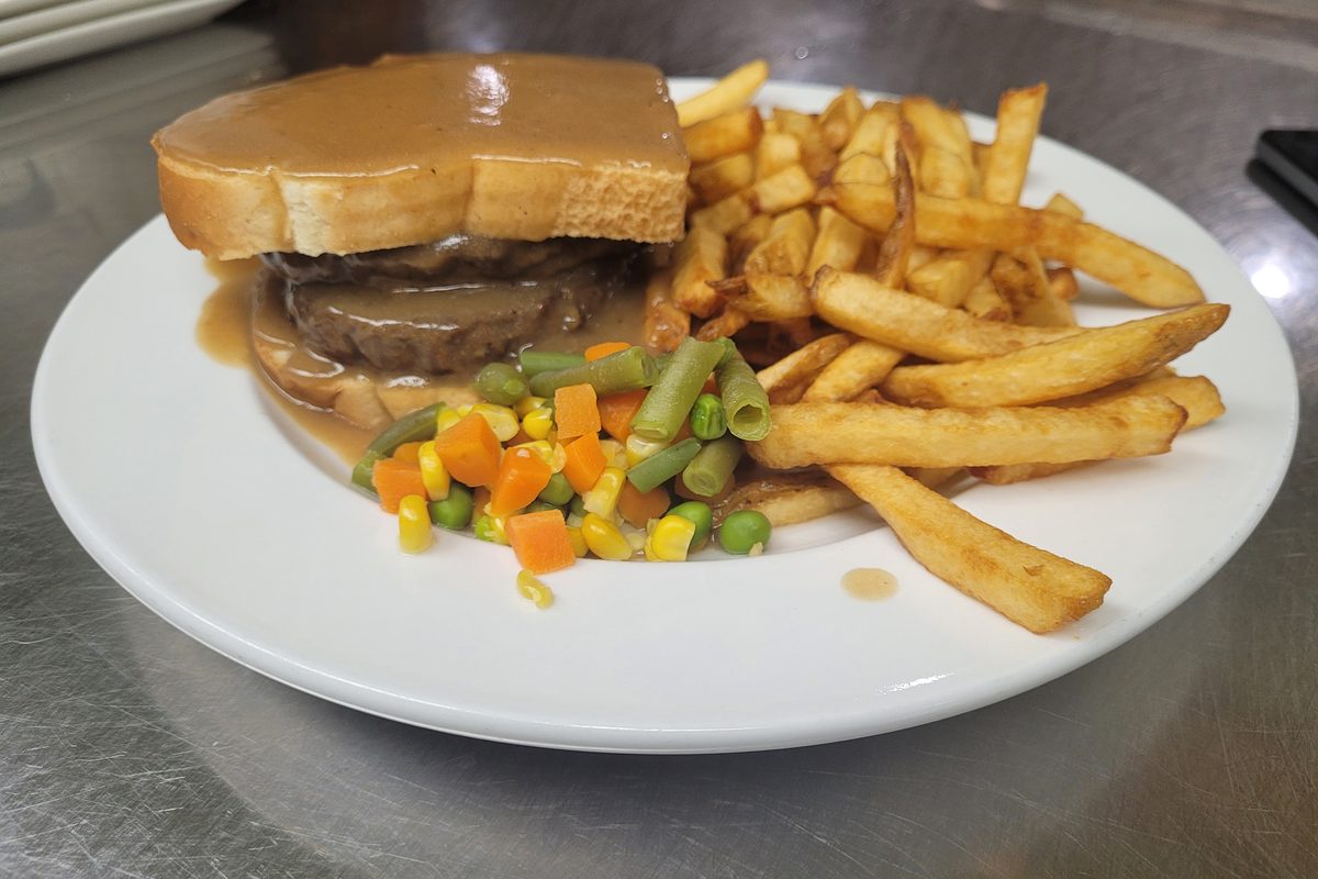 Hot hamburger sandwich with gravy, veggies and fries