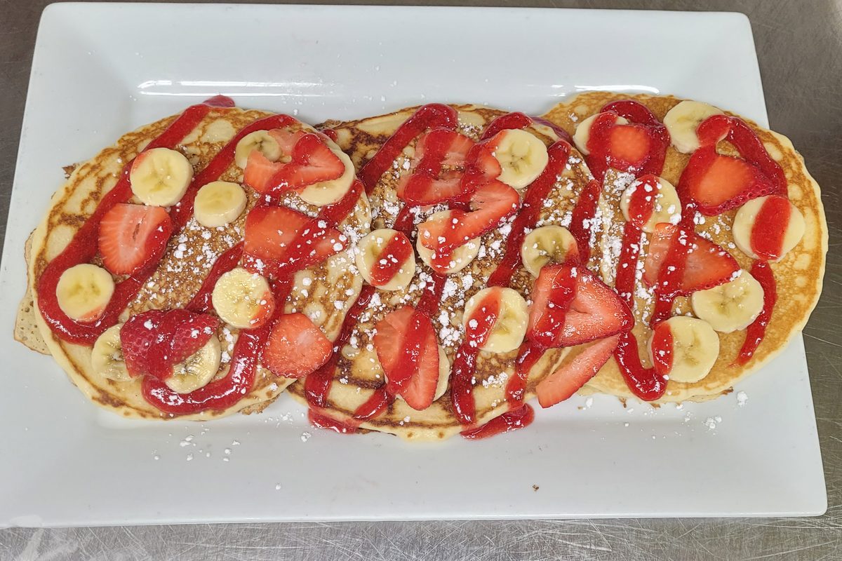 Strawberry banana pancakes with strawberry sauce